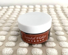 a jar of natural wood incense flakes