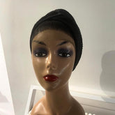 A black turban displayed on a mannequin head.