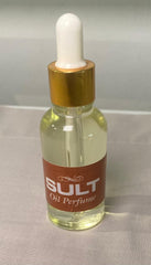 glass of Mini sult Oud Oil Perfume