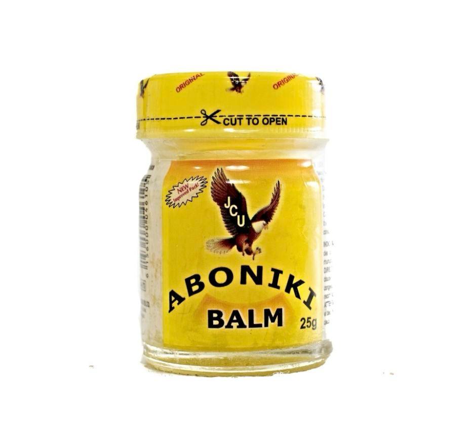 A jar of Aboniki Balm, with a yellow label and a picture of a bird on the lid.