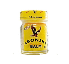A jar of Aboniki Balm, with a yellow label and a picture of a bird on the lid.