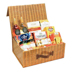 An extra large wicker hamper gift box with an assortment of food items including meats, cheeses, and crackers.