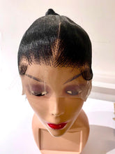 Mannequin head with a black lace wig on a white background