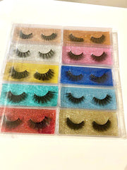 Set of false eyelashes in various colors in a clear plastic case.